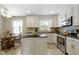 Bright kitchen featuring white cabinetry, black granite countertops, stainless steel appliances, and tile floors at 59 Sycamore Dr, Carmel, IN 46033