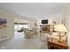 Comfortable living room with fireplace, built-in shelving, and neutral carpet at 59 Sycamore Dr, Carmel, IN 46033