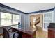Spacious office featuring hardwood floors, a large window, and French doors leading to the hall at 59 Sycamore Dr, Carmel, IN 46033