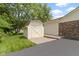 A small wooden shed behind the home has a ramp for easy access and storage space at 59 Sycamore Dr, Carmel, IN 46033