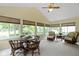 Bright sun room with vaulted ceilings, large windows, and a seating area at 59 Sycamore Dr, Carmel, IN 46033