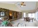 Airy sunroom with neutral carpet, brick accent wall, and transitional decor with view to adjoining living area at 59 Sycamore Dr, Carmel, IN 46033