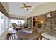 Bright sunroom with vaulted ceilings, large windows, brick accent wall, and game table with seating at 59 Sycamore Dr, Carmel, IN 46033