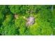 Aerial view of the house surrounded by mature trees, with a backyard firepit area at 6125 N Olney St, Indianapolis, IN 46220