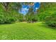 Expansive backyard featuring lush greenery and a charming fire pit area, perfect for outdoor entertaining at 6125 N Olney St, Indianapolis, IN 46220