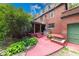 Charming brick home featuring a covered patio and meticulously maintained yard at 6125 N Olney St, Indianapolis, IN 46220