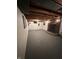 Spacious basement with exposed beams and a brick fireplace at 6125 N Olney St, Indianapolis, IN 46220