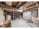 Unfinished basement space showing water heater, shelving, and exposed ceiling at 6125 N Olney St, Indianapolis, IN 46220