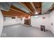 Unfinished basement with exposed ceiling and vintage fireplace at 6125 N Olney St, Indianapolis, IN 46220