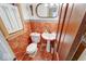 The cozy half bath features beautiful tile work, a pedestal sink, and stylish fixtures at 6125 N Olney St, Indianapolis, IN 46220