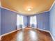 Light-filled bedroom featuring hardwood floors, two windows and two-tone walls at 6125 N Olney St, Indianapolis, IN 46220