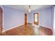 Bedroom with hardwood floors, a door leading outside, and neutral-colored walls at 6125 N Olney St, Indianapolis, IN 46220