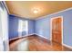 Bedroom with hardwood floors, two-tone walls, and a light-filled window at 6125 N Olney St, Indianapolis, IN 46220