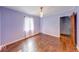 Cozy bedroom with hardwood floors, a pendant light, and neutral-colored walls at 6125 N Olney St, Indianapolis, IN 46220