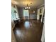 Dining room with hardwood floors, chandelier, large window and gold mirror at 6125 N Olney St, Indianapolis, IN 46220