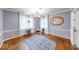 Dining room featuring hardwood floors, an accent mirror, and large windows letting in natural light and beautiful trim at 6125 N Olney St, Indianapolis, IN 46220