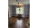 Dining room with hardwood floors, chandelier, and large window at 6125 N Olney St, Indianapolis, IN 46220
