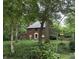 Exterior of beautiful brick home with mature trees and manicured lawn at 6125 N Olney St, Indianapolis, IN 46220