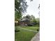Charming brick home with mature landscaping and pathway to front door at 6125 N Olney St, Indianapolis, IN 46220