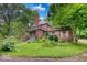 Charming brick home showcasing manicured landscaping, a quaint entrance, and a well-maintained front yard at 6125 N Olney St, Indianapolis, IN 46220