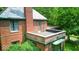 Brick home with lush greenery, showing an upper story outdoor space at 6125 N Olney St, Indianapolis, IN 46220