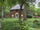 Beautiful brick home with lush lawn, mature trees and slate roof at 6125 N Olney St, Indianapolis, IN 46220