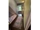 Hallway featuring a decorative runner rug and view from the top of staircase at 6125 N Olney St, Indianapolis, IN 46220