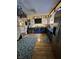 Bright kitchen featuring painted cabinets, wood floors, area rugs, and stainless-steel refrigerator at 6125 N Olney St, Indianapolis, IN 46220