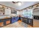 Charming kitchen with unique appliances, contrasting cabinetry, and a large window at 6125 N Olney St, Indianapolis, IN 46220