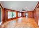Spacious living room features wood-paneled walls, fireplace, and parquet wood flooring at 6125 N Olney St, Indianapolis, IN 46220