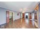 Open living room featuring hardwood floors, neutral paint, and natural lighting at 6125 N Olney St, Indianapolis, IN 46220