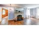 Living room showcasing a fireplace, hardwood floors, large window, and view of the adjacent rooms in the house at 6125 N Olney St, Indianapolis, IN 46220