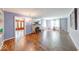 Living room featuring hardwood floors, fireplace, and large windows with natural light and entry to the foyer at 6125 N Olney St, Indianapolis, IN 46220