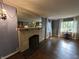 Living room with hardwood floors, fireplace, large mirror and natural light at 6125 N Olney St, Indianapolis, IN 46220