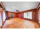 Cozy living room with a wood-burning stove, wood paneling, and an open floor plan at 6125 N Olney St, Indianapolis, IN 46220