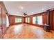Bright living room with wood-paneled walls, parquet wood flooring, and a cozy fireplace at 6125 N Olney St, Indianapolis, IN 46220