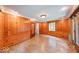 Inviting living room with wood paneling, a window, and access to other rooms at 6125 N Olney St, Indianapolis, IN 46220