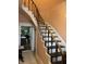 Staircase with a white banister and wooden handrail leading to the upper level at 6125 N Olney St, Indianapolis, IN 46220