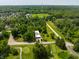 An aerial view showing the manicured golf course, towering trees, and the home near towers at 6164 Afton Crest, Indianapolis, IN 46220