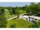 Aerial view of modern home next to a golf course surrounded by lush trees and greenery at 6164 Afton Crest, Indianapolis, IN 46220