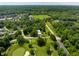 An aerial view showing the manicured golf course, towering trees, and the home near the towers at 6164 Afton Crest, Indianapolis, IN 46220