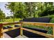 Lush backyard view from a wood deck, highlighting the serene outdoor space and wooded surroundings at 6164 Afton Crest, Indianapolis, IN 46220