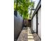 Side yard featuring stone walkway, fence, and modern exterior design at 6164 Afton Crest, Indianapolis, IN 46220