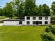 Modern home featuring a minimalist design, expansive windows, and a well-manicured lawn at 6164 Afton Crest, Indianapolis, IN 46220