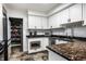 Charming kitchen features granite counters, white cabinets, stainless appliances, and a convenient pantry at 6164 Afton Crest, Indianapolis, IN 46220