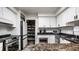 Charming kitchen features granite counters, white cabinets, stainless appliances, and a convenient pantry at 6164 Afton Crest, Indianapolis, IN 46220