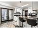 Bright kitchen with granite countertops, stainless appliances, white cabinetry and breakfast bar at 6164 Afton Crest, Indianapolis, IN 46220