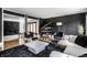 A stylish living room features a grand piano, modern furniture, black accent wall, and hardwood floors at 6164 Afton Crest, Indianapolis, IN 46220
