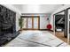 Bright living room featuring a stone fireplace, hardwood floors, and access to a patio at 6164 Afton Crest, Indianapolis, IN 46220
