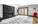 Bright living room featuring a stone fireplace, hardwood floors, and access to a patio at 6164 Afton Crest, Indianapolis, IN 46220